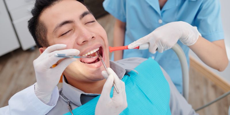 man in dentist chair having a cleaning