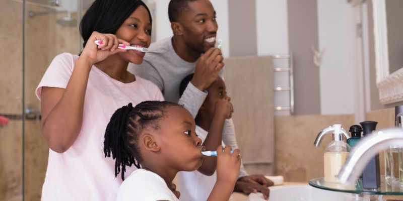 family brushing their teeth together