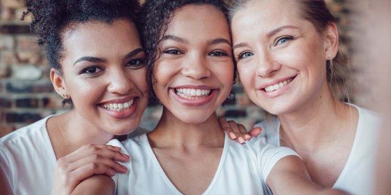 group of three women smiling