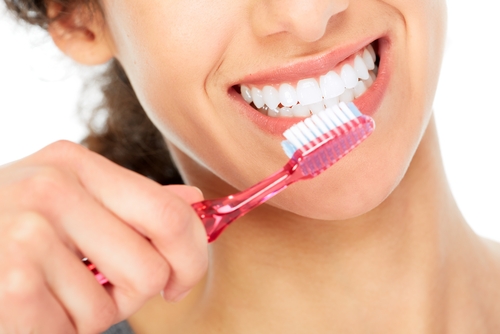 woman brushing her teeth