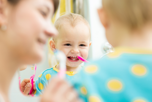 baby brushing her teeth